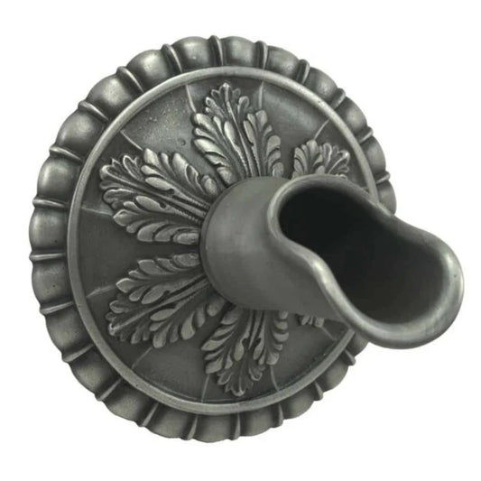 Decorative wall spout with raised leaf design and scalloped circular metal base.