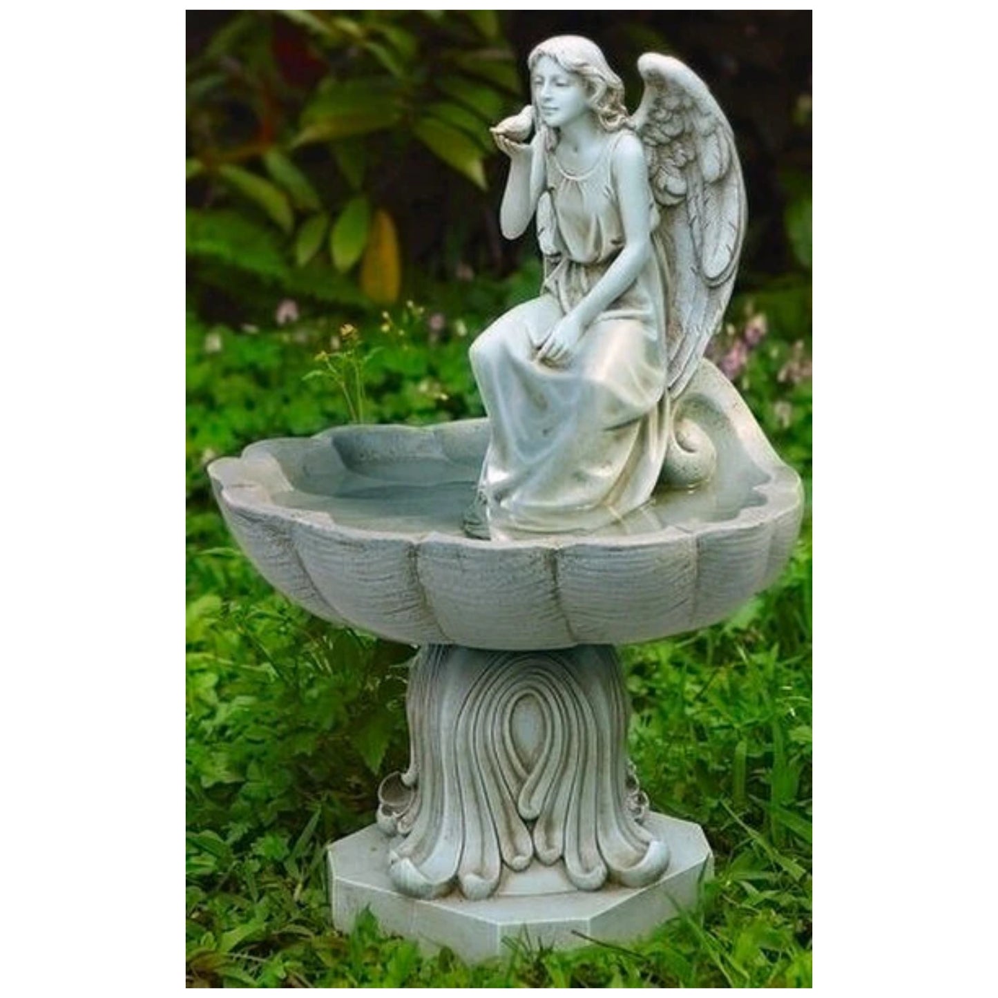 A small lightweight birdbath, with an angle sitting in the bath, her feet in the water. A small bird on her hand, right in front of her face.