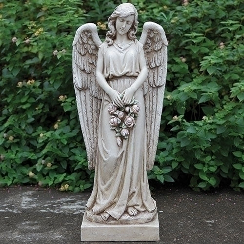 Statue of an angel holding flowers in a garden setting
