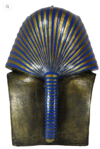 An ancient Egyptian-style headdress mask with a blue and gold striped fan-shaped crown and a blue striped vertical front panel, mounted on a bronze-toned rectangular base with engraved markings.