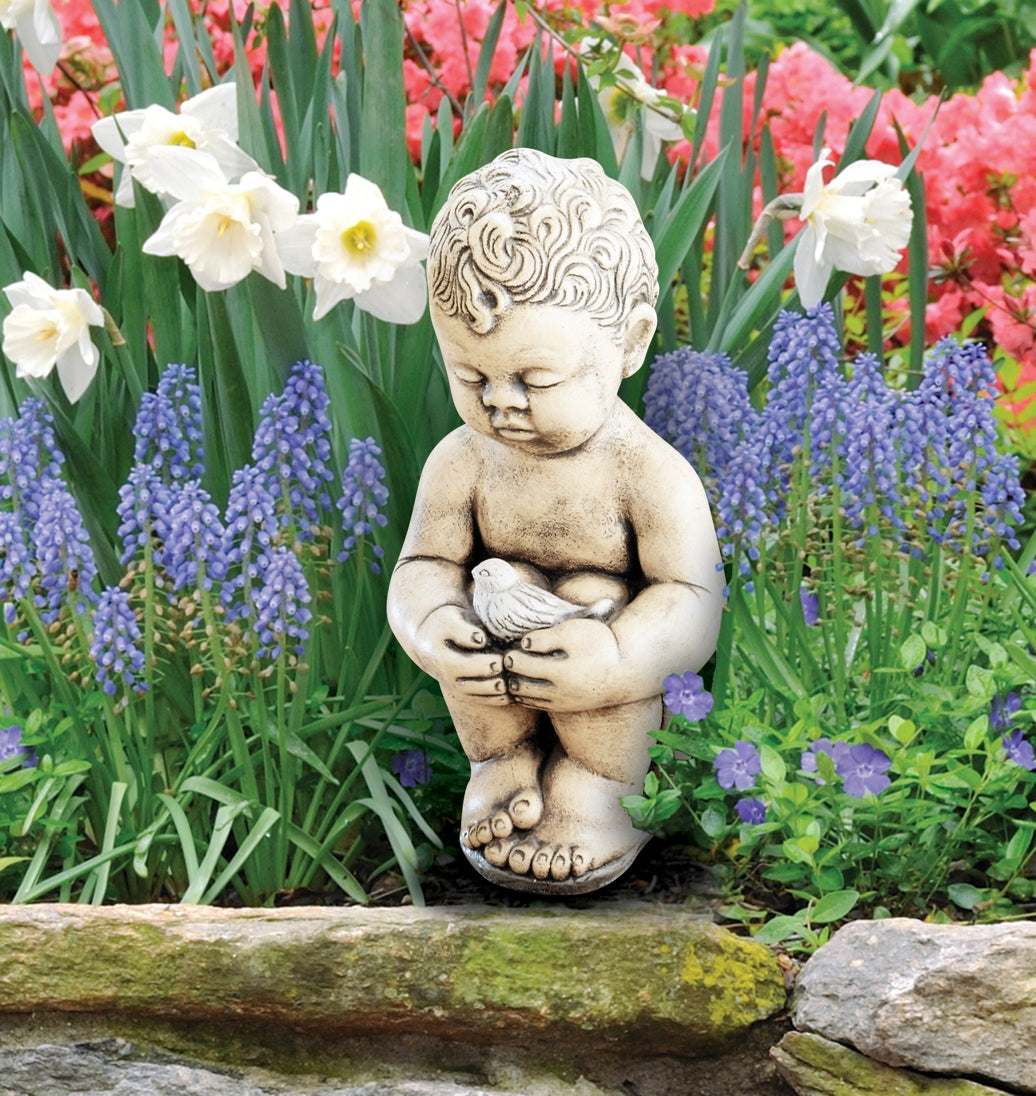 Sweet child figure holding a bird, cast in stone with vintage charm