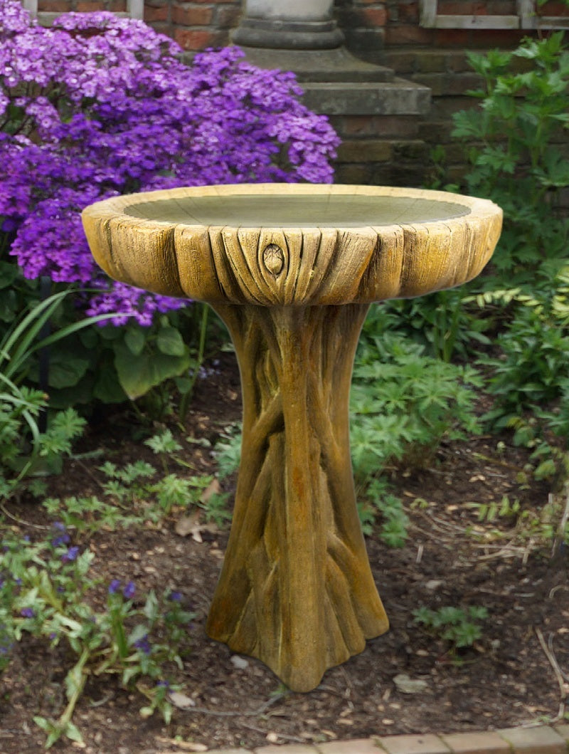 Outdoor driftwood birdbath with natural rustic texture