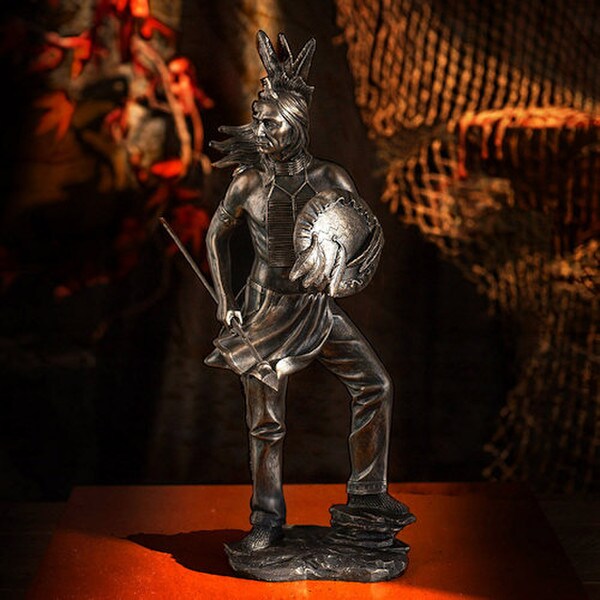 statue depicts a Native American warrior shield and spear figurine