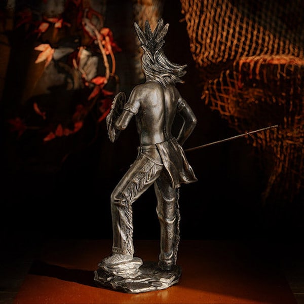 statue depicts a Native American warrior spear and shield artwork