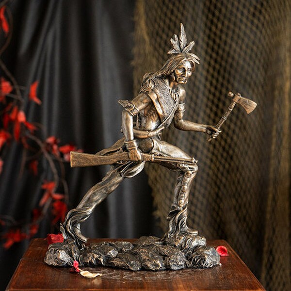 statue depicts a Native American warrior shield and spear figurine