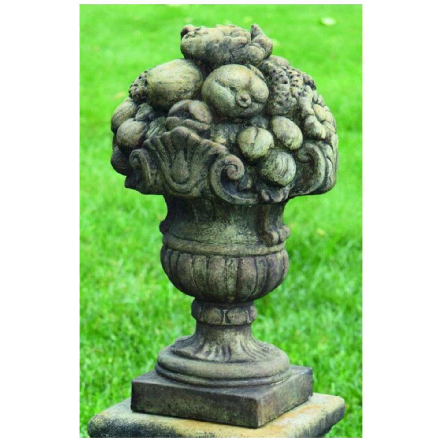 Stacked fruit sculpture with detailed apples, grapes, and pears forming a decorative garden finial.