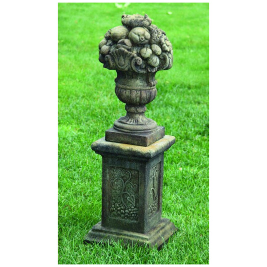 Stacked fruit sculpture with detailed apples, grapes, and pears forming a decorative garden finial.