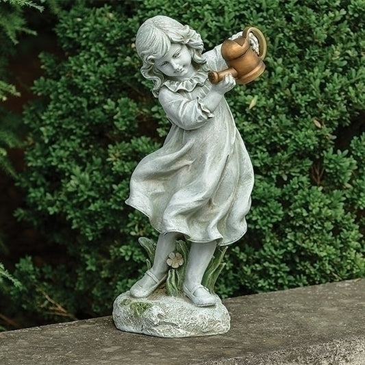 Statue of a girl holding a watering can against a green bush background