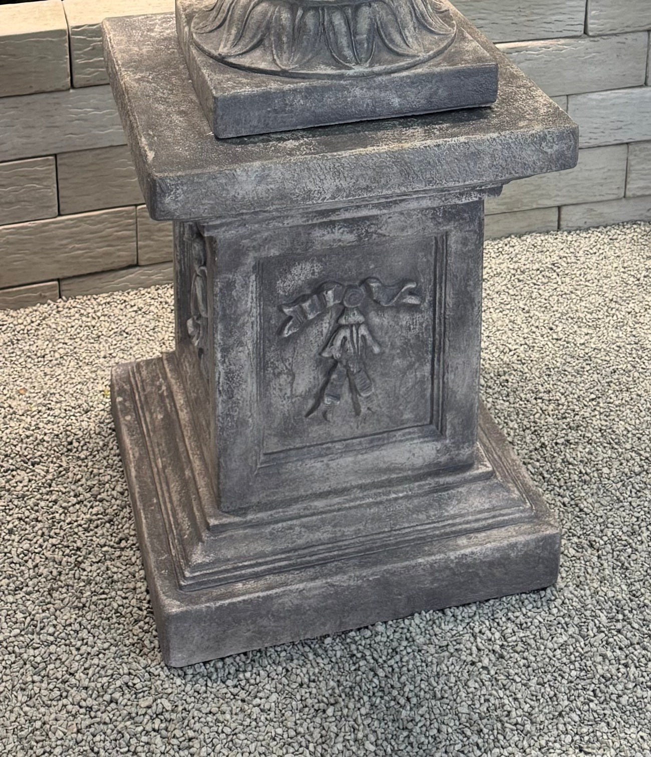Close up of column grand ram head estate garden urn on pedestal