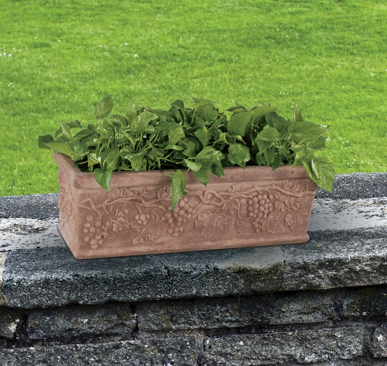 Forty-inch grapevine garden trough planter displayed on stone wall