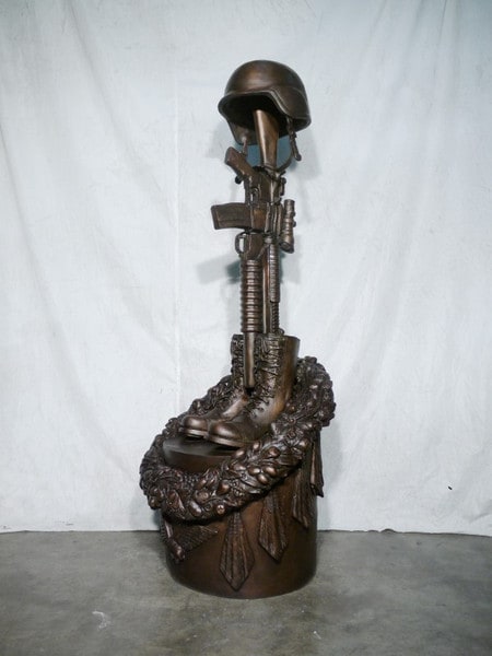 War Memorial one battle cross boots gun and helmet memorial statues