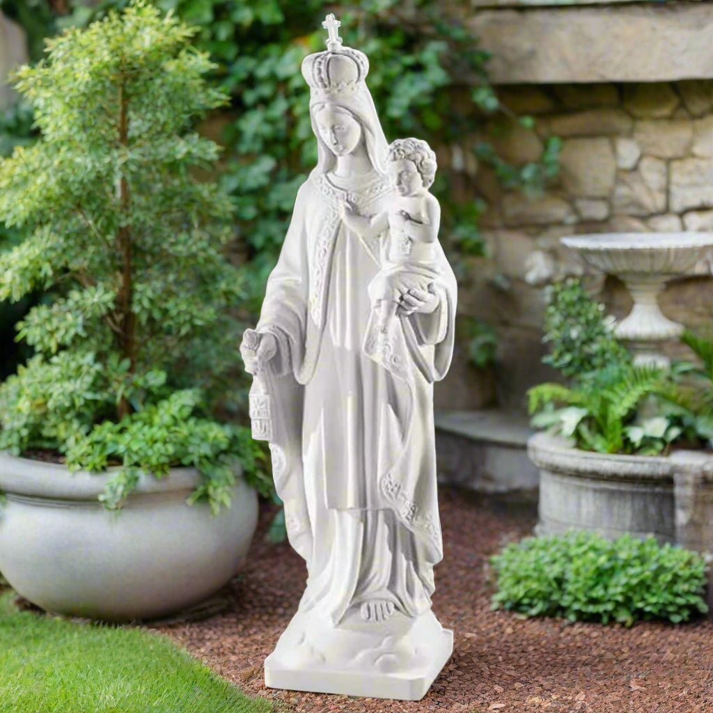 32-inch Lady of Mount Carmel statue in white Italian marble, placed in a landscaped prayer garden with floral and natural stone background