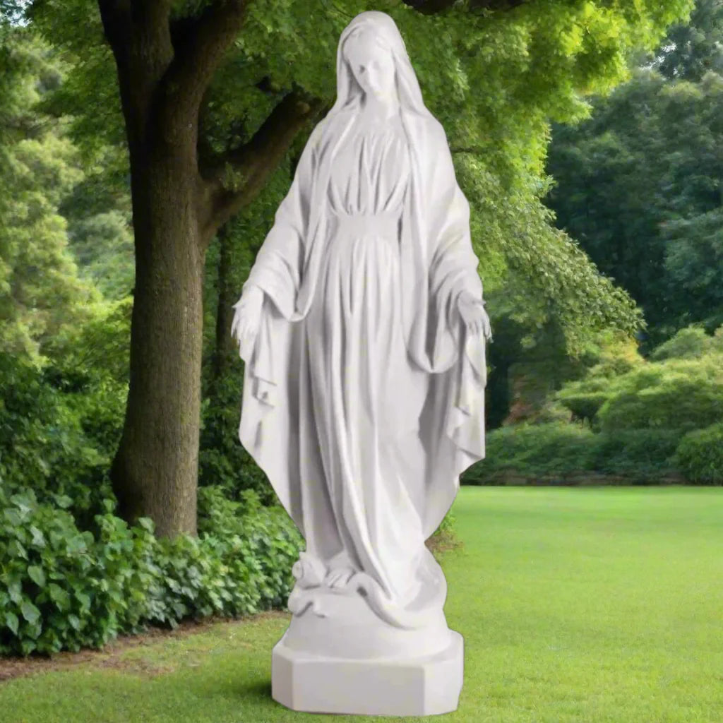 Bonded marble Virgin Mary statue, life-size and serene, shown outdoors with flowers and greenery surrounding a memorial-style base