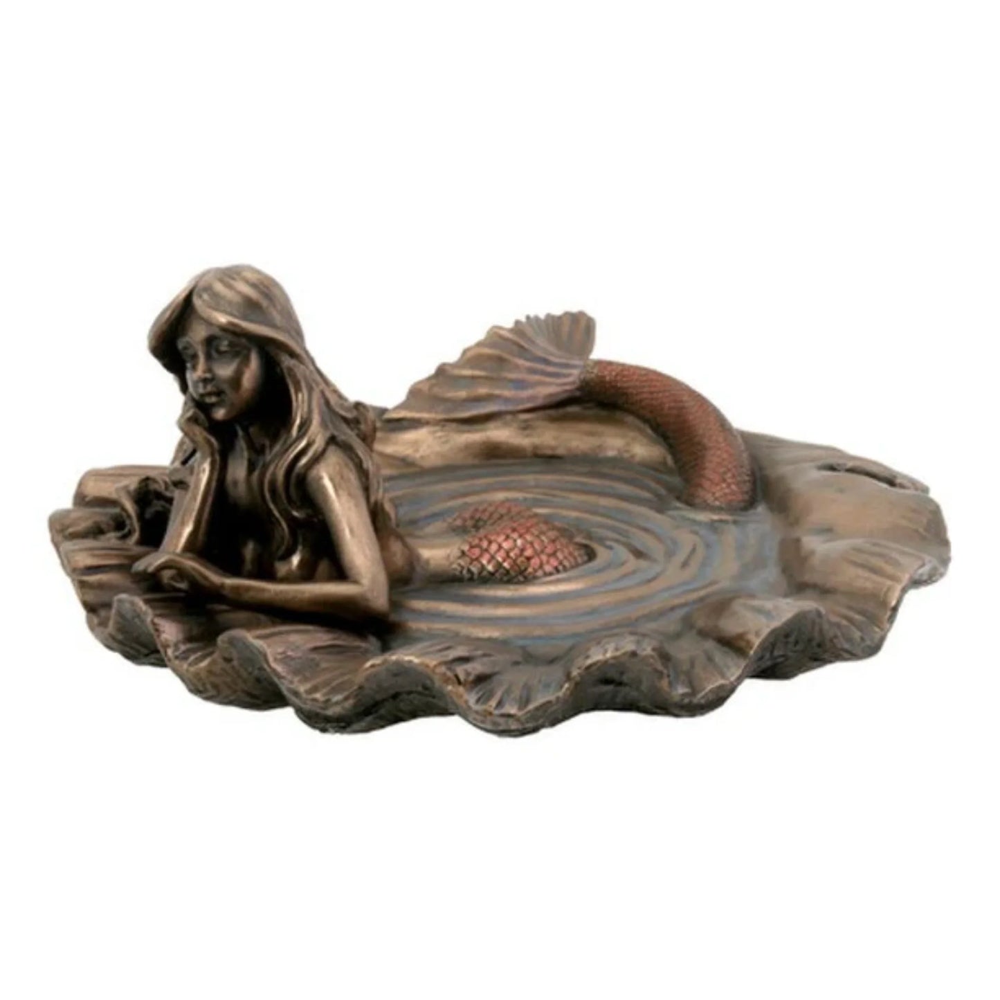 mermaid resting in pool of water inside of sea shell sculpture