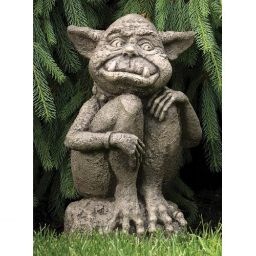 statue of an Ogre has pointed eared, with two fangs that protrude from his bumpy mischievous smile