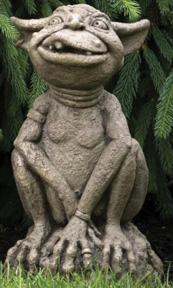 Orson Ogre Cement Garden Statue Stone gargoyle statue against a green leafy background