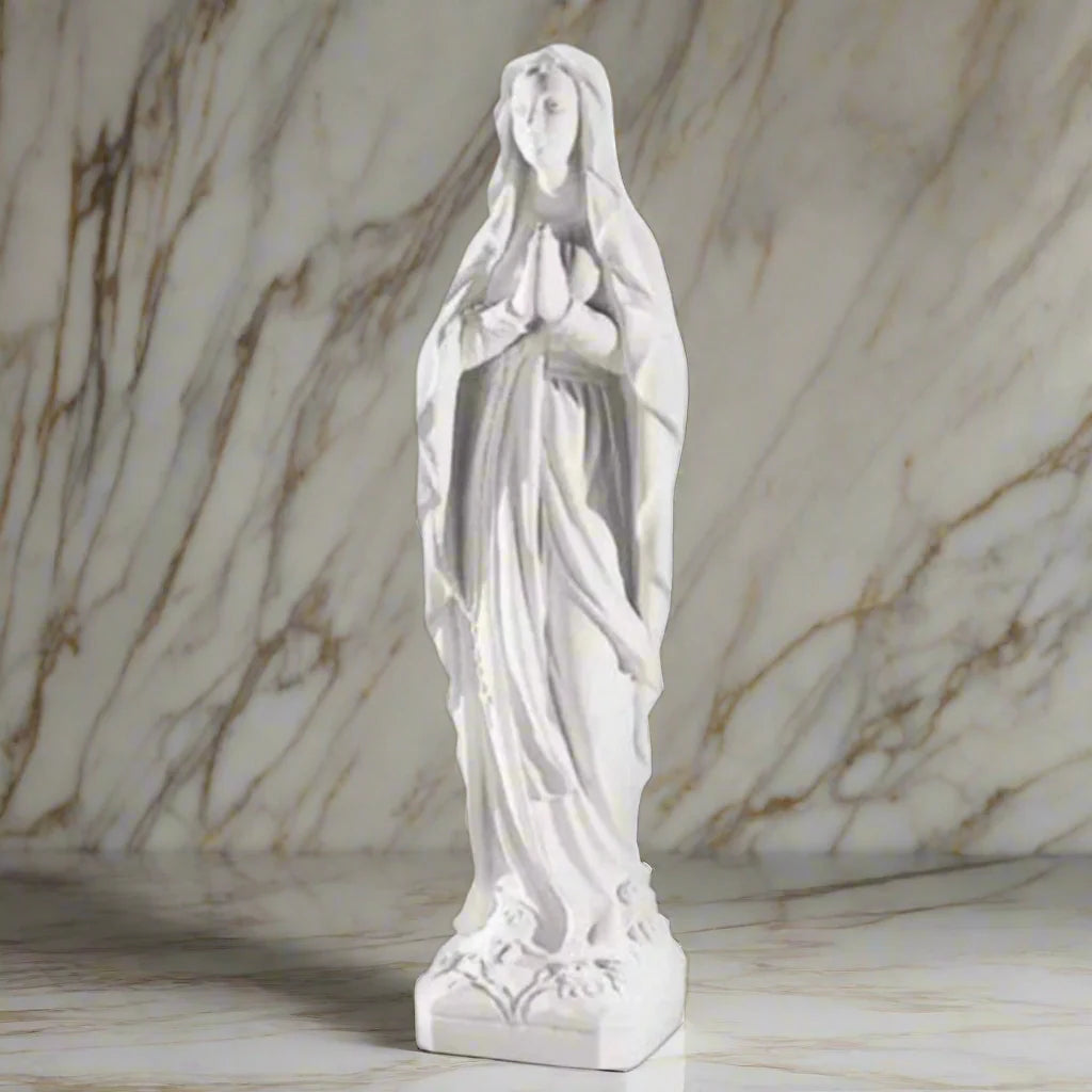 43.5-inch Our Lady of Lourdes statue in white Italian marble, displayed in a tranquil garden shrine with floral arrangements and greenery