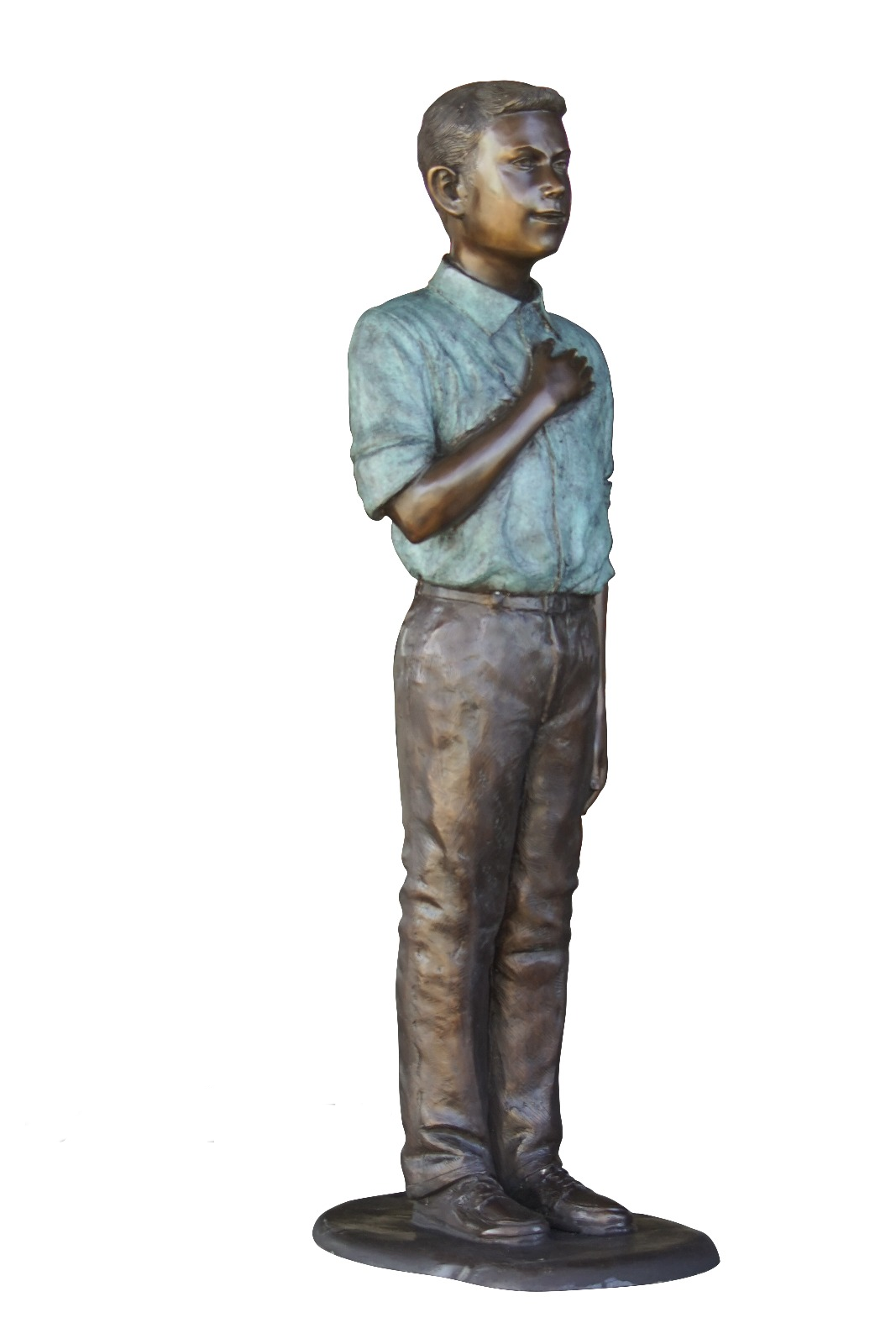 Bronze statue of a young boy standing with his hand over his heart on a white background