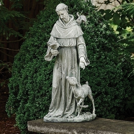 Statue of Saint Francis with a deer in a garden setting