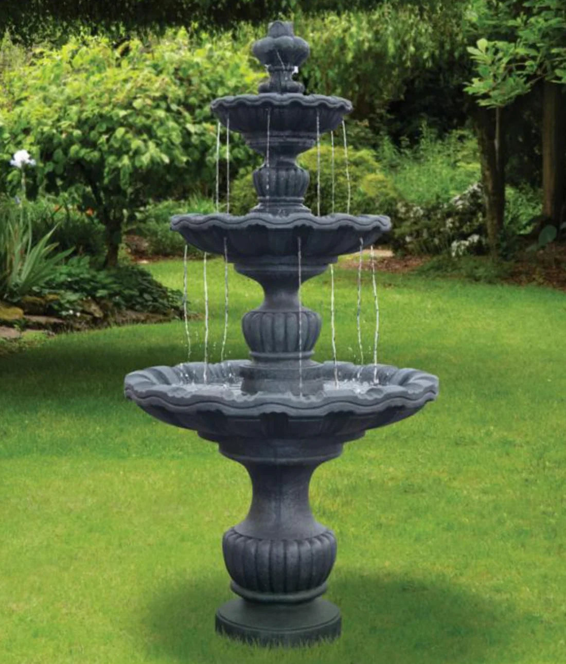 Three-tiered outdoor fountain in a garden setting many spillways