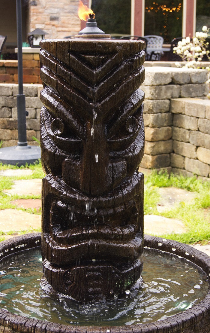 Tiki torch with water feature in a garden setting Polynesian flame fountain sculptural