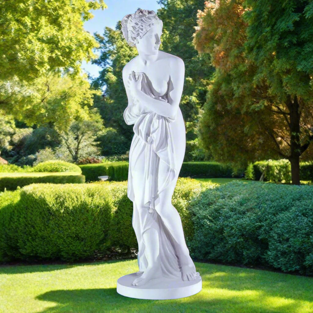 Venus Italica statue by Canova in bonded Carrara marble, outdoors on a sunny day in a lush landscape