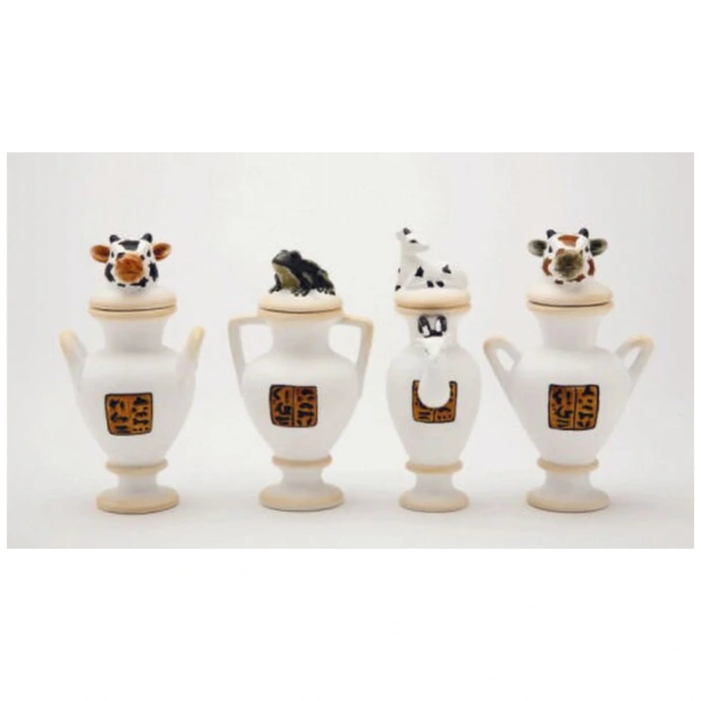 Four canopic jars or vases, a different design on each and a different animal on each lid.