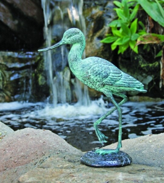Life size bronze wild animal bird heron or crane standing outdoors