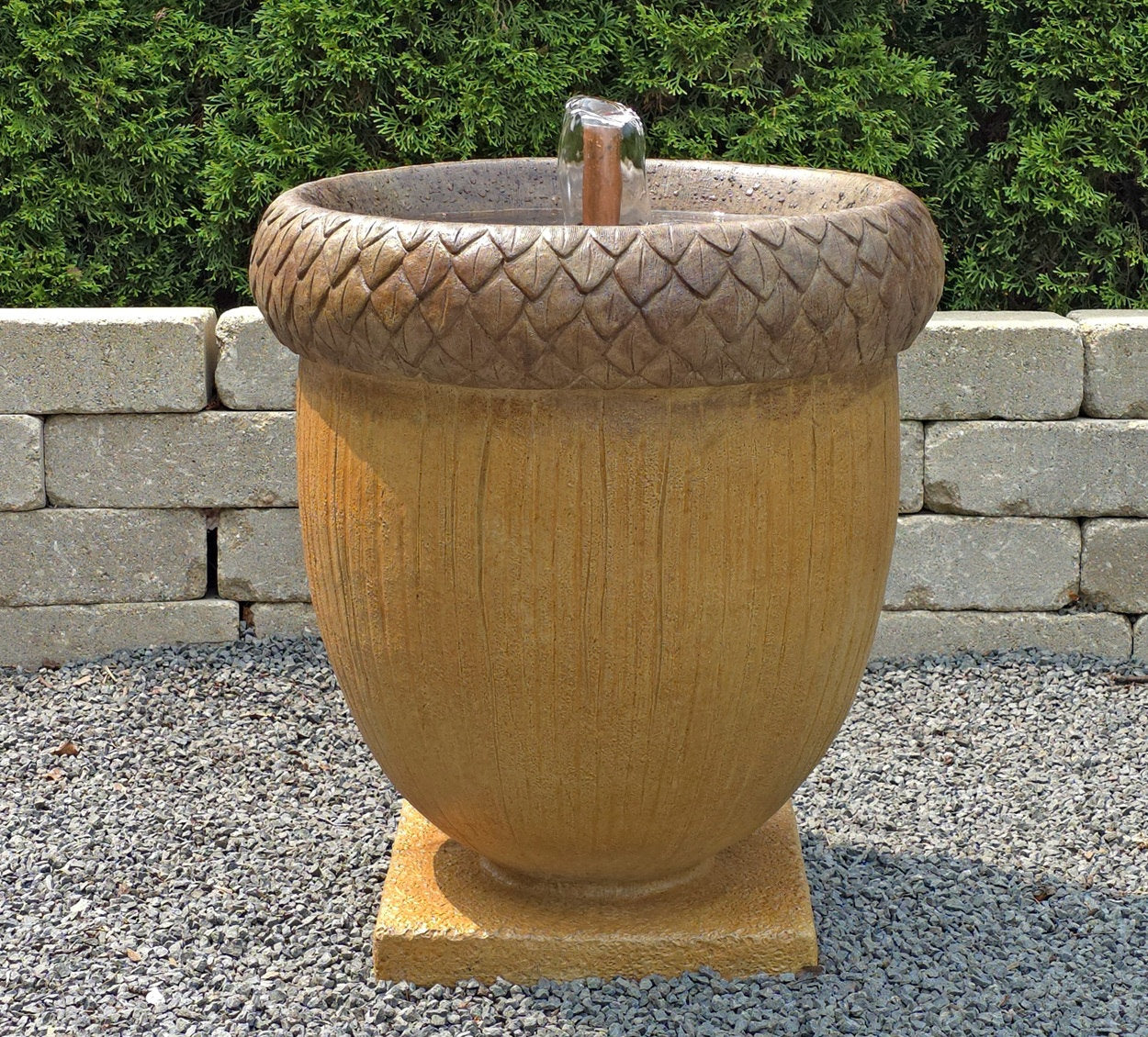 Acorn-shaped garden fountain with textured top and bubbling water feature