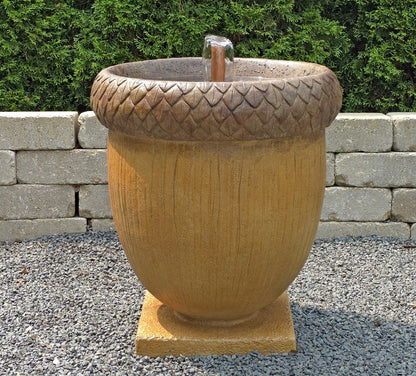 Acorn-shaped garden fountain with textured top and bubbling water feature