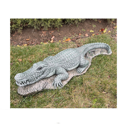 Alligator water feature spouting garden statue fountain crafted for outdoor landscapes. Detailed gator sculpture creates a dramatic focal point for ponds and pools.