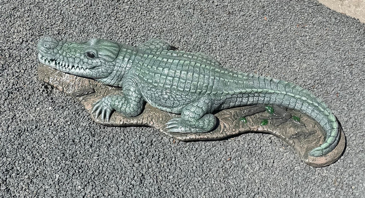 Bronze alligator sculpture on a textured surface water fountain piped statue