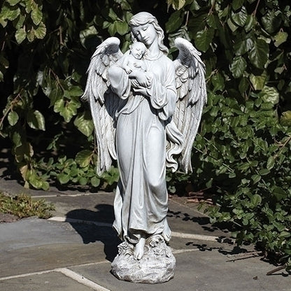 Statue of an angel holding a child in a garden setting