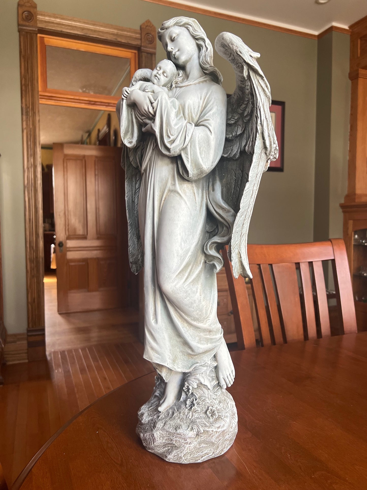 angel cradling baby detailed wings garden décor