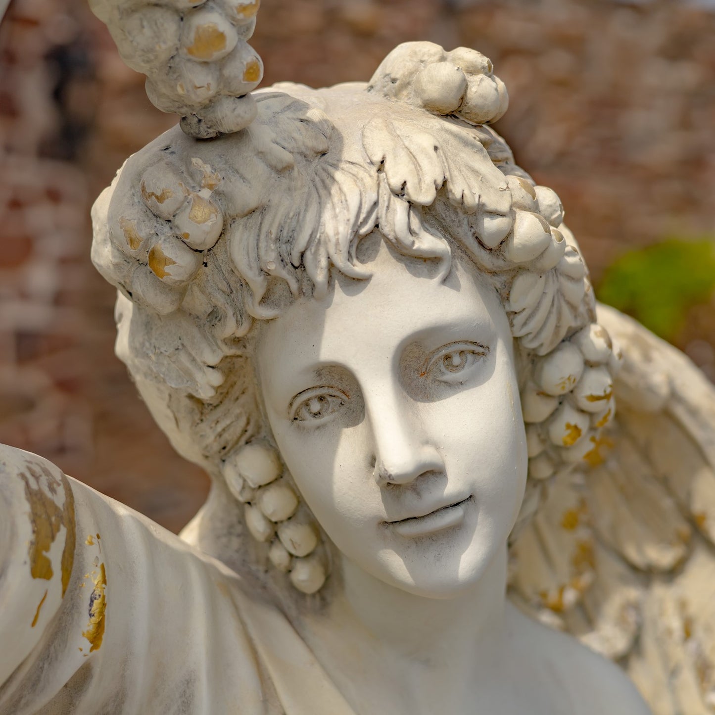 Angel of the Harvest Life-Size Garden Statue close up of face and grapes