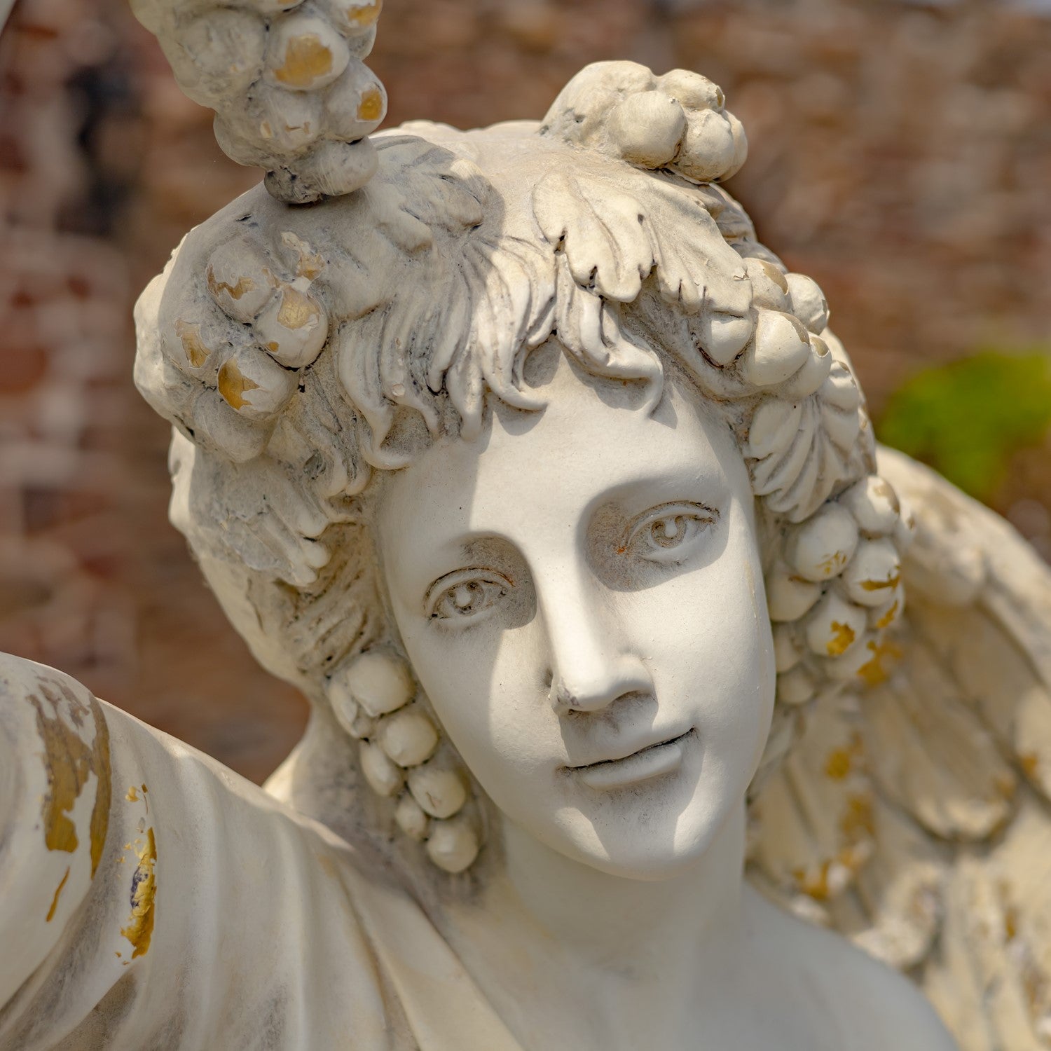 Angel of the Harvest Life-Size Garden Statue close up of face and grapes