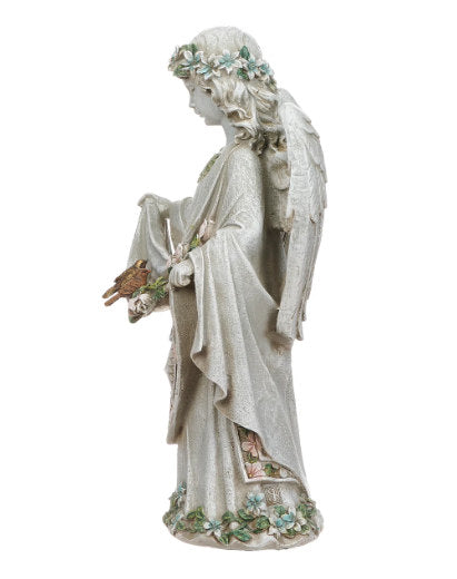 Side View sweet angel is sculpted with soft curls, floral detailing, and outstretched wings, holding the hem of her gown to cradle two perched bird