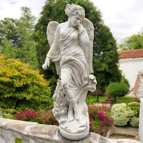 Statue of an angel in a garden setting with greenery and flowers Neoclassical Angel of Compassion Sculpture