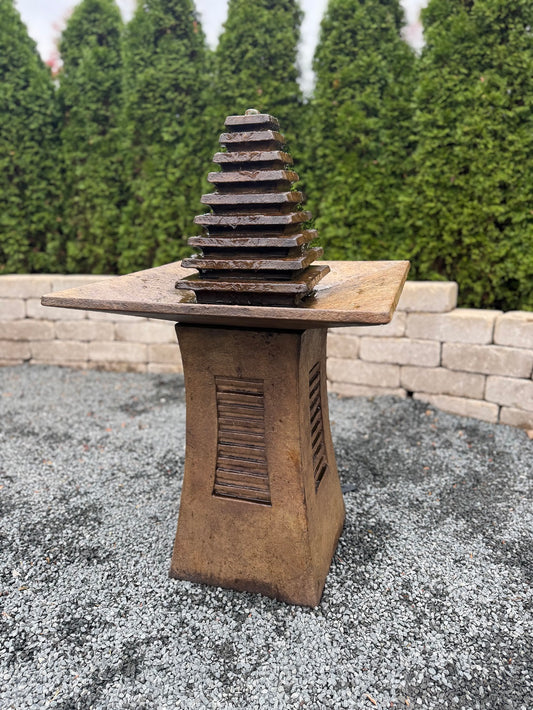 The Astor Garden Cement Fountain stands 36.5 inches high and delivers a striking balance of architectural structure and tranquil movement