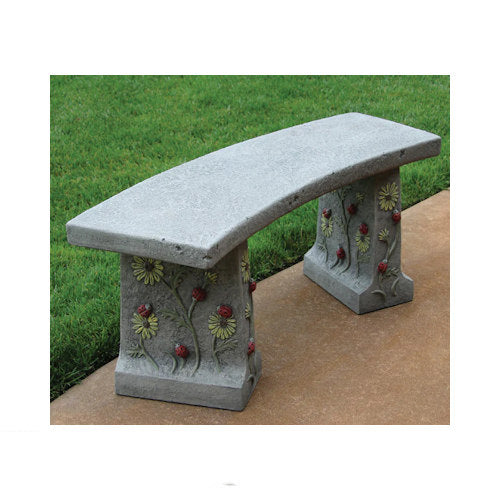 Decorative stone bench with floral designs on a grassy background with ladybugs high reliefs