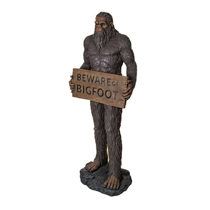 Statue of a creature holding a 'Beware of Bigfoot' sign on a white background