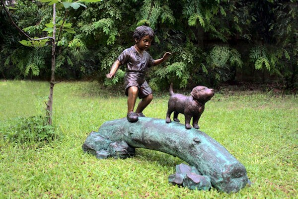 Boy Following Dog Across Log Bronze Statue