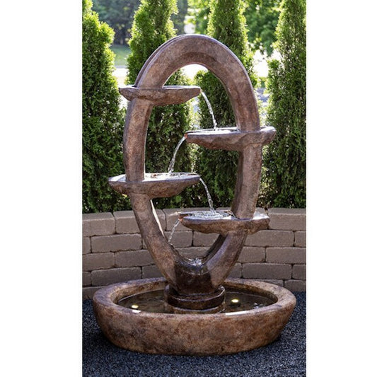 Ellipse fountain flowing back and forth between intricately carved stone scuppers