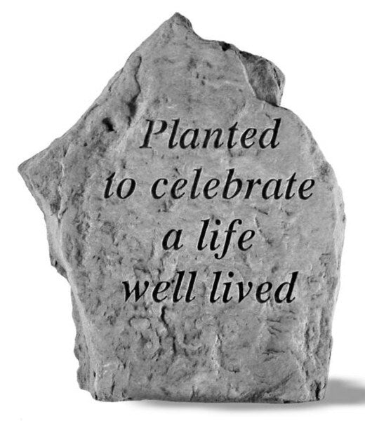 Stone garden memorial that reads Planted to celebrate a life well lived