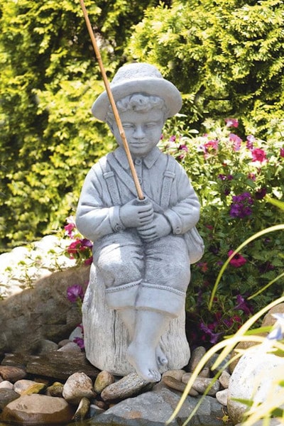 ceramics of huckleberry finn holding a fish pole for outdoors Boy Fishing Huck Finn On Ledge Statue