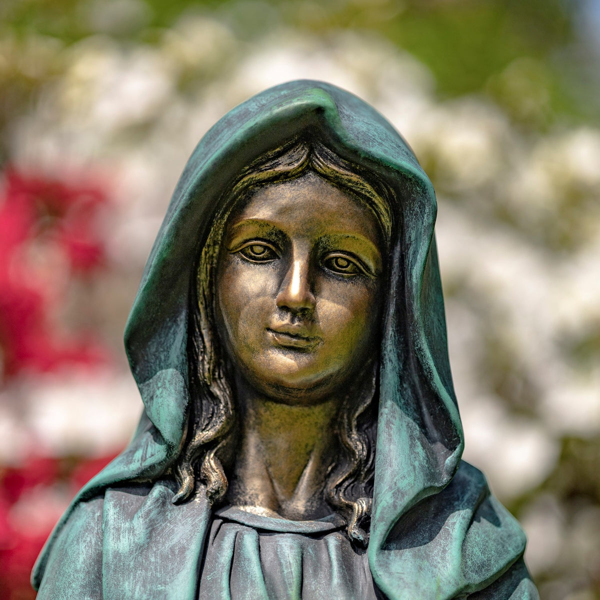 Close up of face Catholic Blessed Mother sculpture for prayer garden