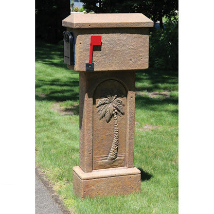 Decorative mailbox with palm tree relief design on a grassy lawn