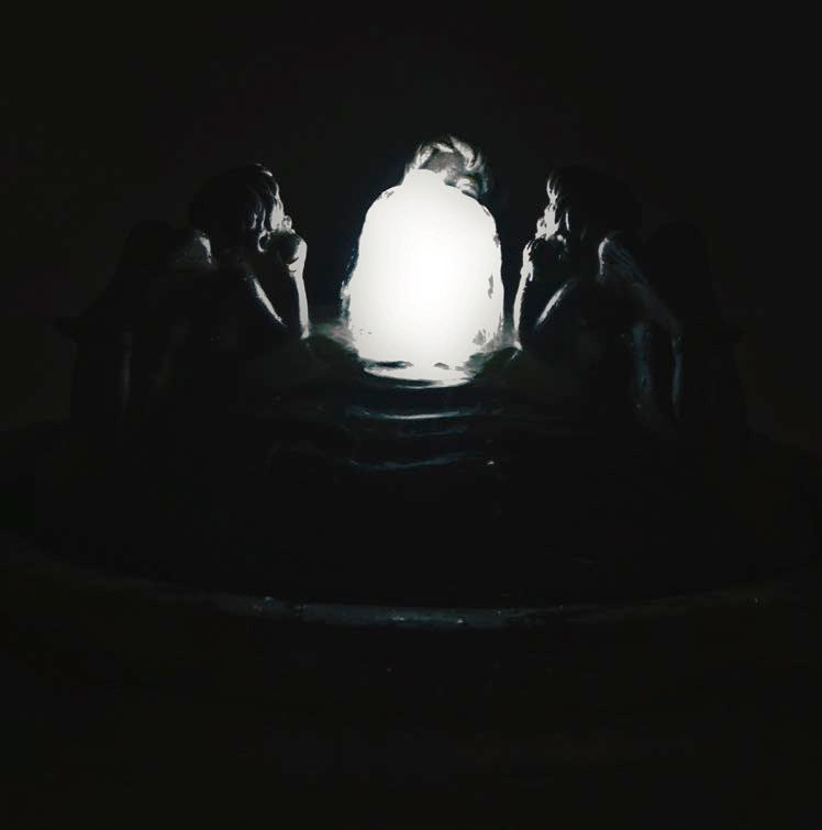 Three Cherubs Resting Bubbler Fountain night time view of water feature