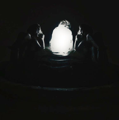 Three Cherubs Resting Bubbler Fountain night time view of water feature