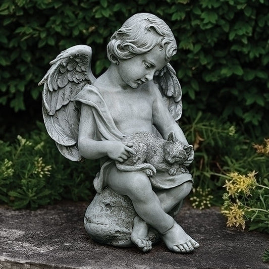 Statue of an angel holding a cat in a garden setting